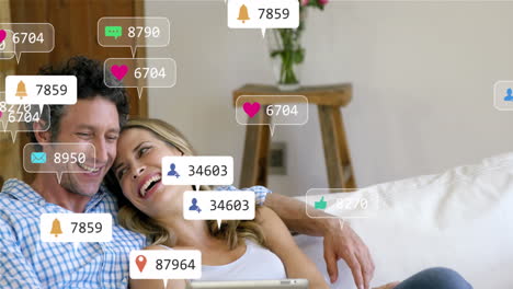 Animation-of-notification-bars-over-caucasian-couple-relaxing-and-watching-video-on-digital-tablet