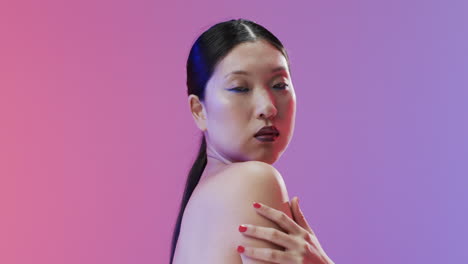 Asian-woman-with-black-hair-and-make-up-looking-at-camera,-copy-space,-slow-motion