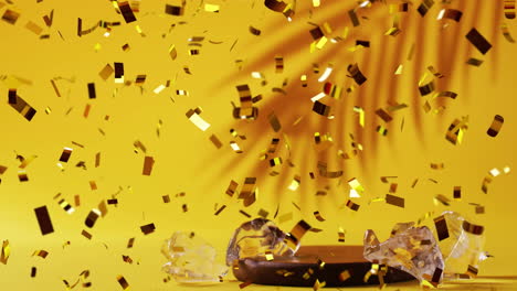 Animation-of-confetti-falling-and-cocktail-on-yellow-background