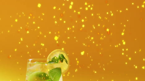 Animation-of-confetti-falling-and-cocktail-on-yellow-background