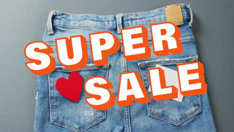 Animation-of-super-sale-text-over-denim-trousers-background