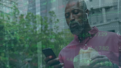Animation-of-bars-and-trading-board,-senior-african-american-man-with-food-scrolling-on-cellphone