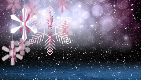 Animation-of-christmas-decorations-and-snow-falling-on-dark-background
