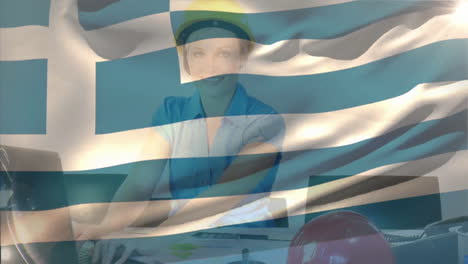 Animation-of-greece-flag-waving-over-smiling-caucasian-woman-wearing-helmet-working-on-computer
