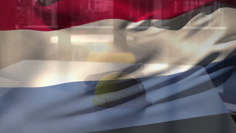 Animation-Der-Niederländischen-Flagge-über-Einem-Gelben-Helm-Und-Einem-Grundriss-Auf-Einem-Tisch-Vor-Einem-Glasfenster