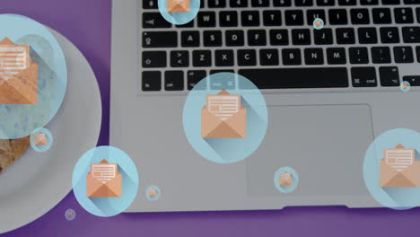 Animation-of-letter-in-open-envelope-icons,-overhead-view-of-laptop-and-croissants-in-plate