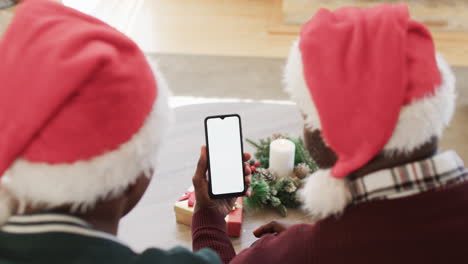 Happy-african-american-father-and-son-smartphone-christmas-video-call,-copy-space,-slow-motion