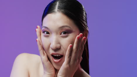 Shocked-asian-woman-with-black-hair-and-make-up-looking-at-camera,-copy-space,-slow-motion