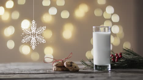 Animation-of-snowflake-christmas-decorations,-cookies-and-glass-of-milk-on-grey-background