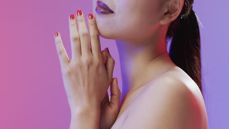 Asian-woman-with-black-hair-and-make-up-touching-her-chin,-copy-space,-slow-motion
