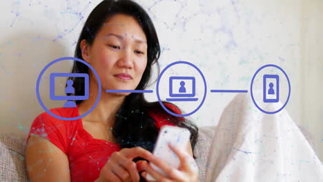 Animation-of-flowchart-and-connected-icons-over-asian-woman-scrolling-on-smartphone-at-home