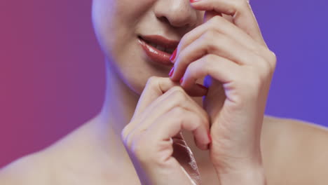 Asian-woman-with-black-hair-and-make-up-touching-hands,-copy-space,-slow-motion