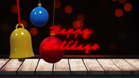 Animation-of-illuminated-red-happy-holidays-text-and-lens-flares-with-colorful-baubles-over-table