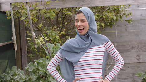 Portrait-of-smiling-biracial-woman-in-hijab-with-copy-space,-slow-motion