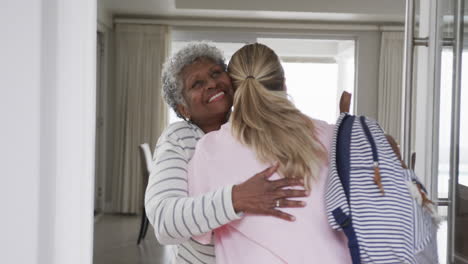 Smiling-caucasian-nurse-hugging-with-senior-african-american-woman-patient,-slow-motion