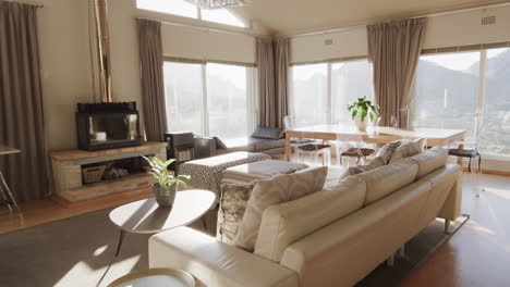 Furnished-living-room-interior-with-large-sunny-windows,-copy-space,-slow-motion