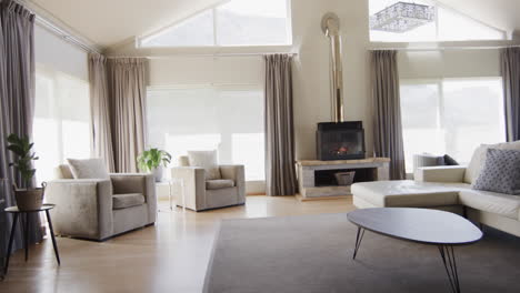 General-view-of-modern-living-room-with-fireplace-and-furniture-with-copy-space,-slow-motion