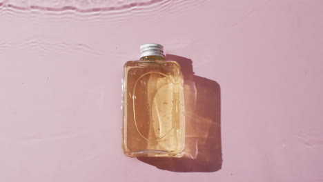 Video-Einer-Kosmetikflasche-Im-Wasser-Mit-Kopierraum-Auf-Rosa-Hintergrund