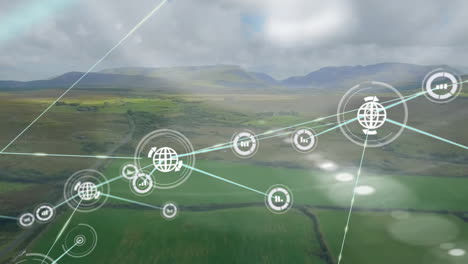 Animation-of-connected-icons-over-aerial-view-of-moving-vehicle-beside-green-land-against-mountains