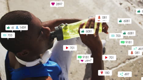Animation-of-multiple-notification-bars,-overhead-view-of-african-american-athlete-drinking-water