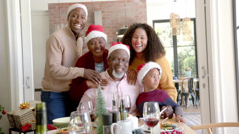 Portrait-of-happy-african-american-multi-generation-family-at-christmas-dinner-table