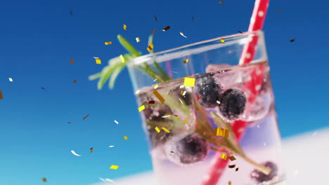 Animation-of-confetti-falling-and-cocktails-on-blue-background