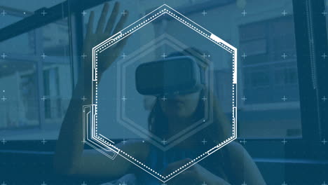 Animation-of-loading-hexagon-over-caucasian-woman-gesturing-while-using-vr-headset-in-office
