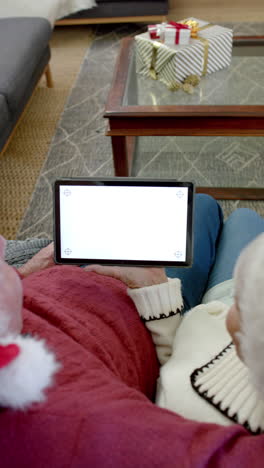 Vertical-video-of-senior-caucasian-couple-using-tablet-with-copy-space-on-screen,-slow-motion
