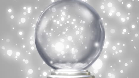 Animation-of-snow-globe-over-snow-falling-on-grey-background