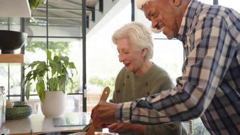 Glückliches,-Vielfältiges-Seniorenpaar-In-Der-Küche-Bereitet-Weihnachtsessen-Zu,-Zeitlupe