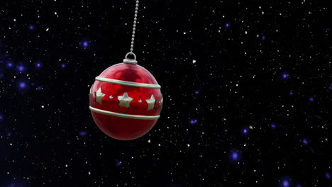 Animation-of-christmas-red-bauble-and-snow-falling-on-blue-background