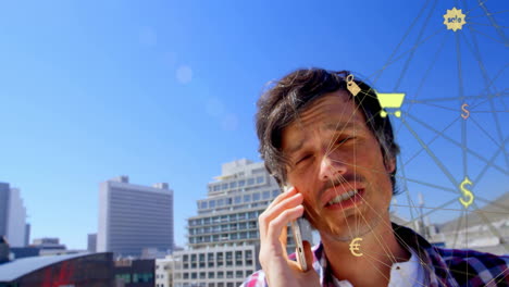 Animation-of-connected-icons-forming-globe-over-caucasian-man-talking-on-cellphone-against-buildings