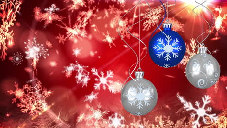 Animation-of-hanging-baubles,-snowflakes-and-lens-flare-over-red-background