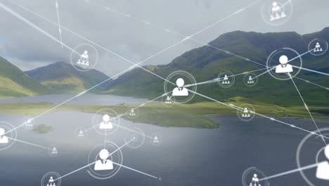 Animation-of-connected-icons-over-aerial-view-of-lake-between-mountains-against-cloudy-sky