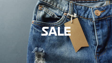 Animation-of-sale-text-over-denim-trousers-background