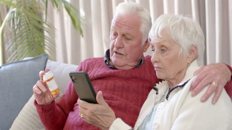 Senior-caucasian-couple-using-smartphone-for-online-doctor-consultation-at-home,-slow-motion