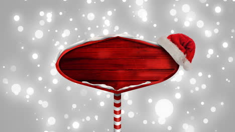 Animation-Eines-Roten-Schildes-Mit-Weihnachtsmütze,-Auf-Grauem-Hintergrund-Fallende-Lichtpunkte