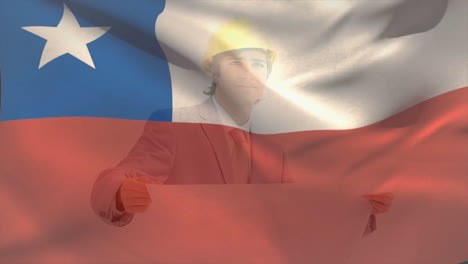Animation-of-chile-flag,-caucasian-engineer-wearing-helmet-standing-and-looking-at-blueprint
