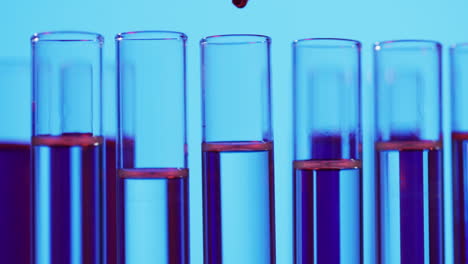 Video-of-laboratory-test-tubes-with-copy-space-on-blue-background