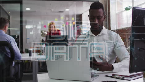 Animation-of-big-data-text-over-african-american-man-talking-on-cellphone-while-working-on-laptop
