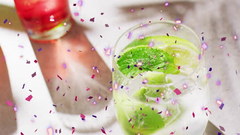 Animation-of-confetti-falling-and-cocktails-on-white-background