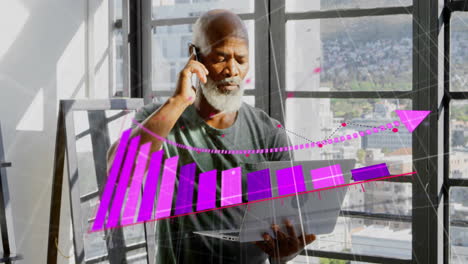 Animation-of-arrow-on-graph-over-senior-african-american-man-with-laptop-talking-on-smartphone