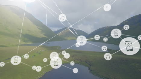 Animation-of-connected-icons-over-aerial-view-of-lakes-between-mountains-against-cloudy-sky