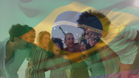 Animation-of-flag-of-brazil-over-smiling-diverse-friends-standing-and-forming-human-chain-at-beach