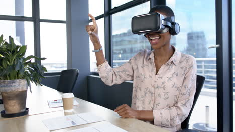 African-american-businesswoman-using-vr-headset-in-office,-slow-motion,-copy-space