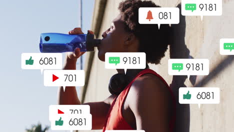 Animation-of-icons,-changing-numbers-in-notification-bars,-african-american-athlete-drinking-water