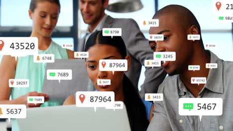 Composite-of-notification-icons-with-changing-numbers-over-diverse-colleagues-discussing-over-laptop