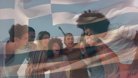 Animation-of-flag-of-greece,-low-angle-view-of-diverse-laughing-friends-forming-human-chain-at-beach