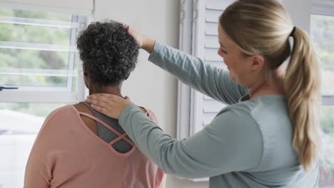 Caucasian-female-physiotherapist-checking-neck-of-senior-woman,-copy-space,-slow-motion