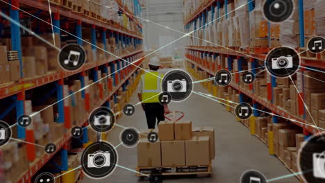 Animation-of-connected-icons,-caucasian-workers-moving-cardboard-boxes-using-hand-truck-in-warehouse